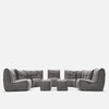 A modulær sofa fra Ambient Lounge, denne moderne stueløsning har tuftet puter og består av to hjørnedeler, to armløse deler og fire puffer, arrangert i en U-form på hvit bakgrunn.